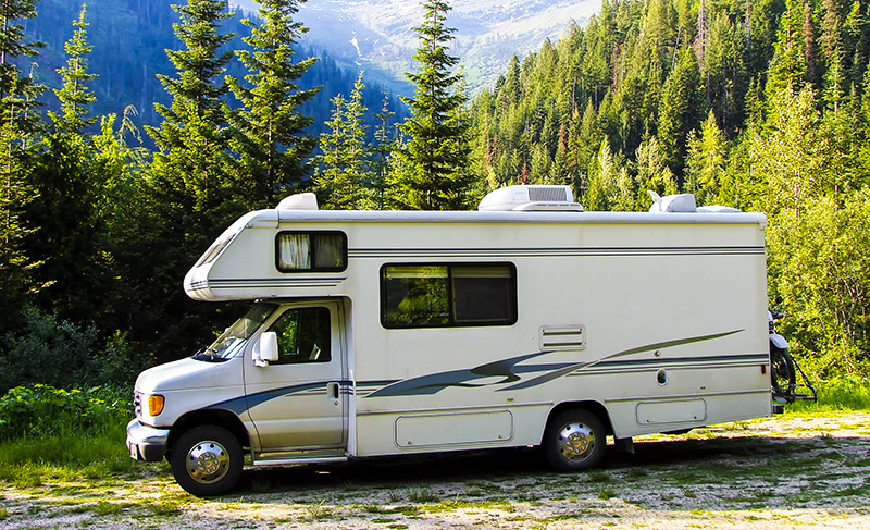 Recreational Vehicle Insurance - A recreational vehicle parked in the mountain woodland.