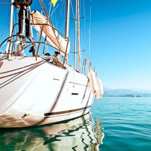 Boat Insurance - Close up of a sailboat on calm blue ocean.