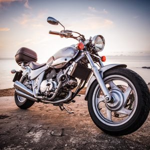 Motorcycle Insurance - A Shiny motorcycle on a point overlooking the sea.