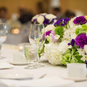 Wedding Insurance - A table setting with flowers and empty glasses.