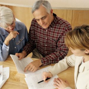 Life Insurance - A family confers over documents.