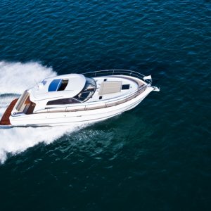 Motorsports Insurance - A speedboat cutting through blue water.